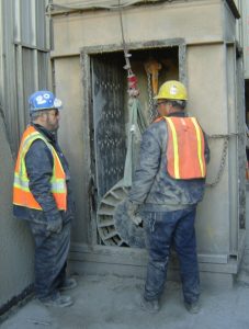 Technicians servicing a conveyor