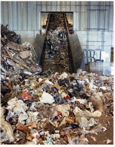 Recyclable waste products being loaded onto a conveyor